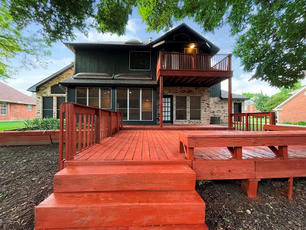 1840 Wind Hill Road Rockwall, TX 75087 - Photo 5 of 28 a view of a wooden deck front of house