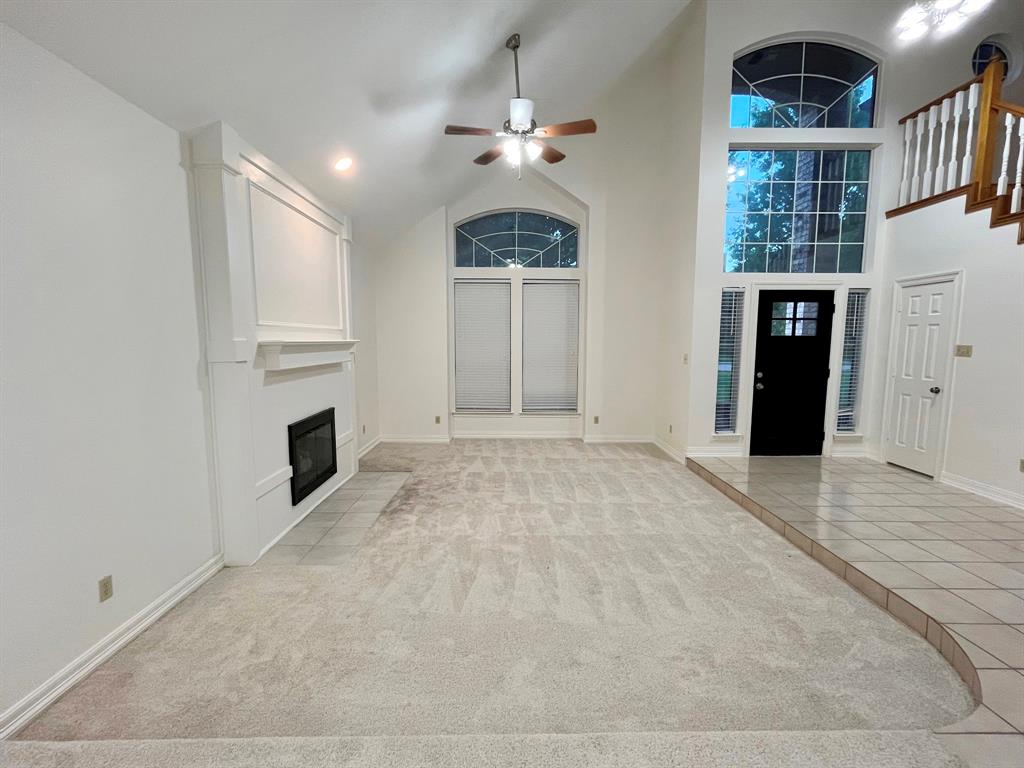 1840 Wind Hill Road Rockwall, TX 75087 - Photo 7 of 28 a view of an empty room with a fireplace and a window