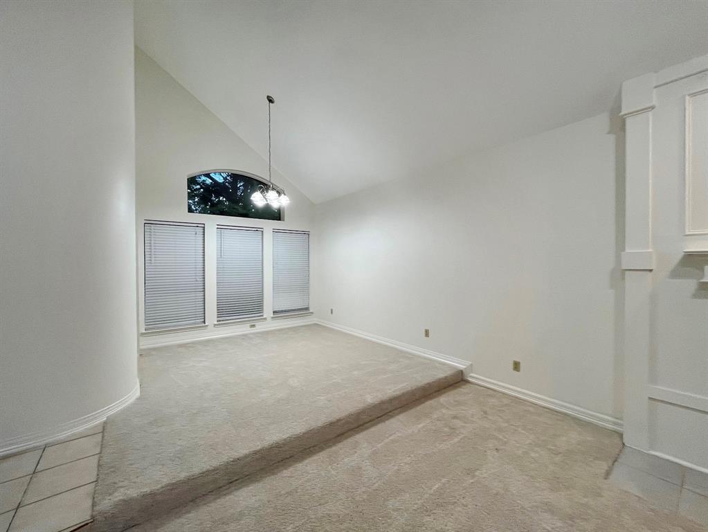1840 Wind Hill Road Rockwall, TX 75087 - Photo 10 of 28 an empty room with a chandelier fan and refrigerator