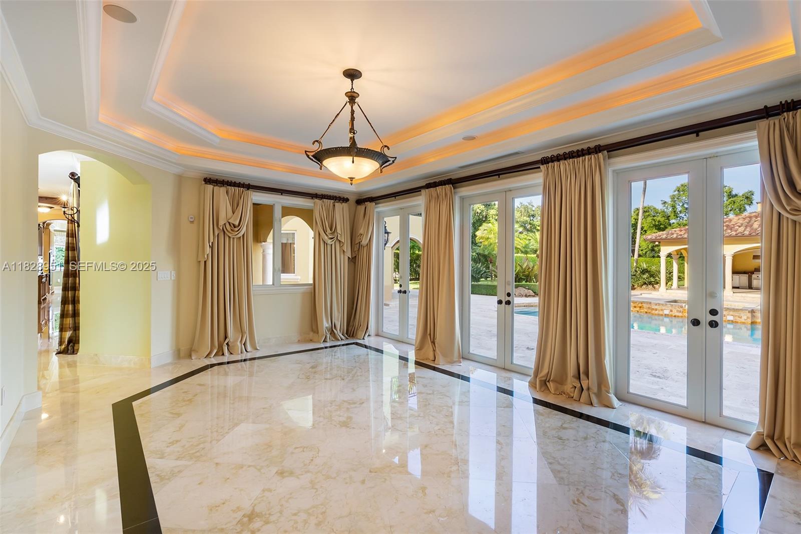 10851 Southwest 63rd Avenue Pinecrest, FL 33156 - Photo 16 of 63 a view of a livingroom with wooden floor and a chandelier