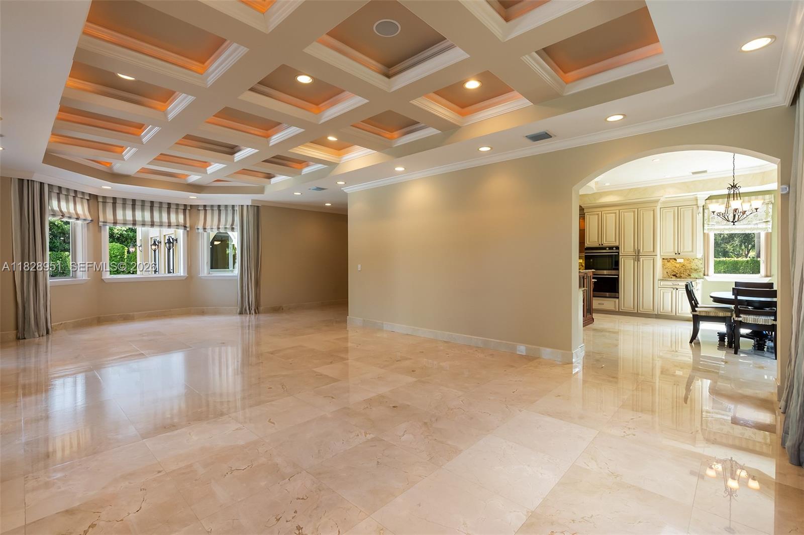 10851 Southwest 63rd Avenue Pinecrest, FL 33156 - Photo 19 of 63 an empty room with wooden floor and a chandelier