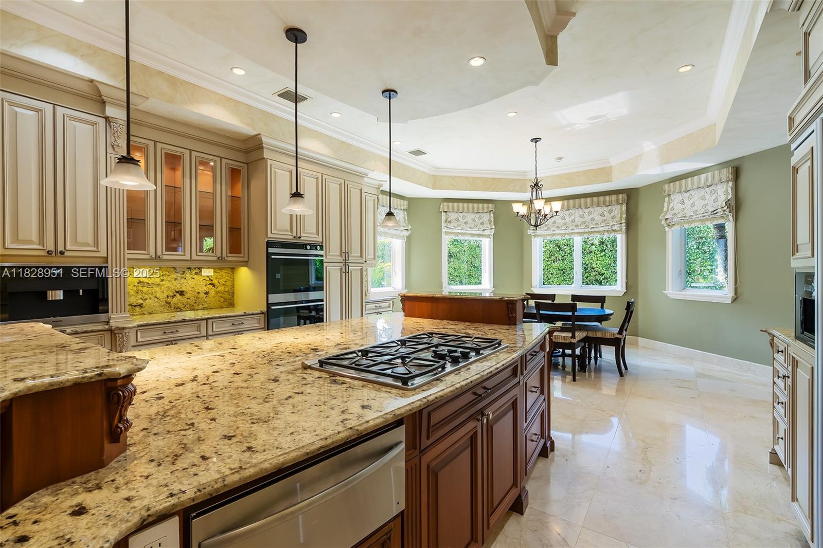 10851 Southwest 63rd Avenue Pinecrest, FL 33156 - Photo 22 of 63 a kitchen with a stove a refrigerator and a table