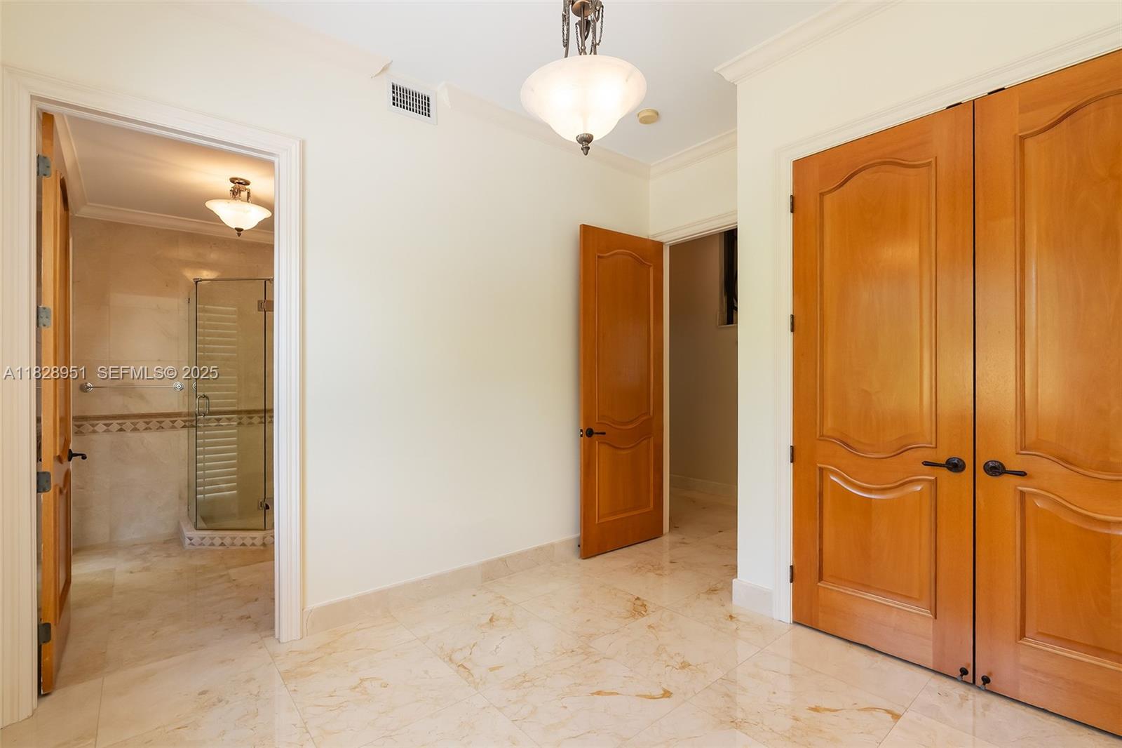 10851 Southwest 63rd Avenue Pinecrest, FL 33156 - Photo 25 of 63 an empty room with closet and a chandelier fan