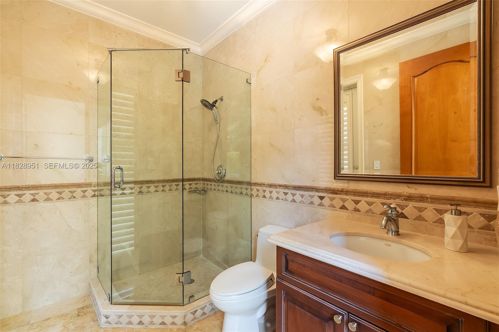 10851 Southwest 63rd Avenue Pinecrest, FL 33156 - Photo 26 of 63 a bathroom with a granite countertop sink a toilet and shower