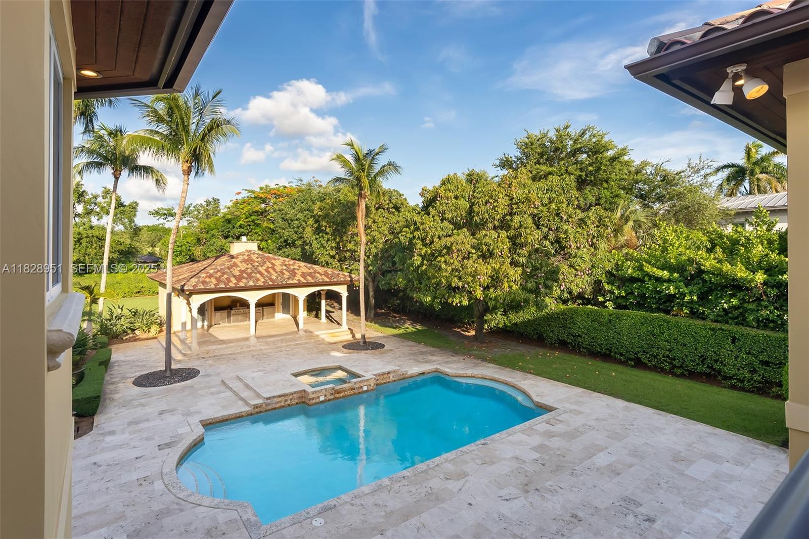 10851 Southwest 63rd Avenue Pinecrest, FL 33156 - Photo 46 of 63 a view of a swimming pool with a yard