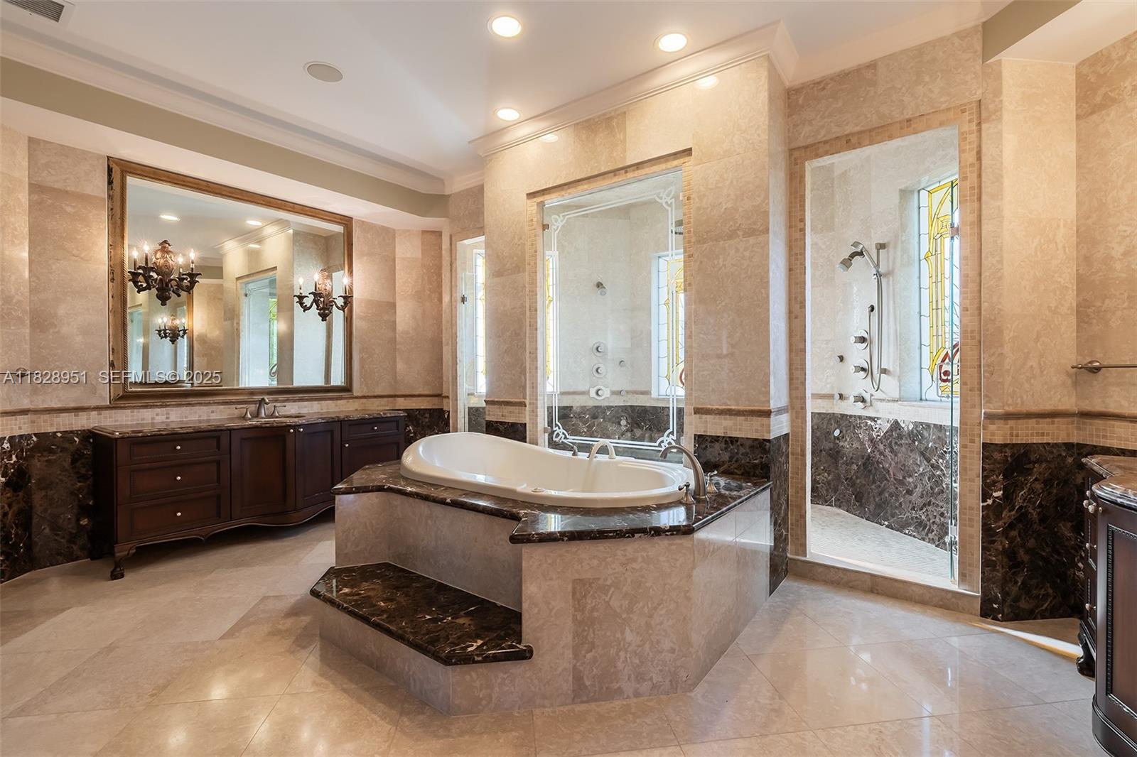 10851 Southwest 63rd Avenue Pinecrest, FL 33156 - Photo 49 of 63 a bathroom with a granite countertop sink a toilet a mirror and shower