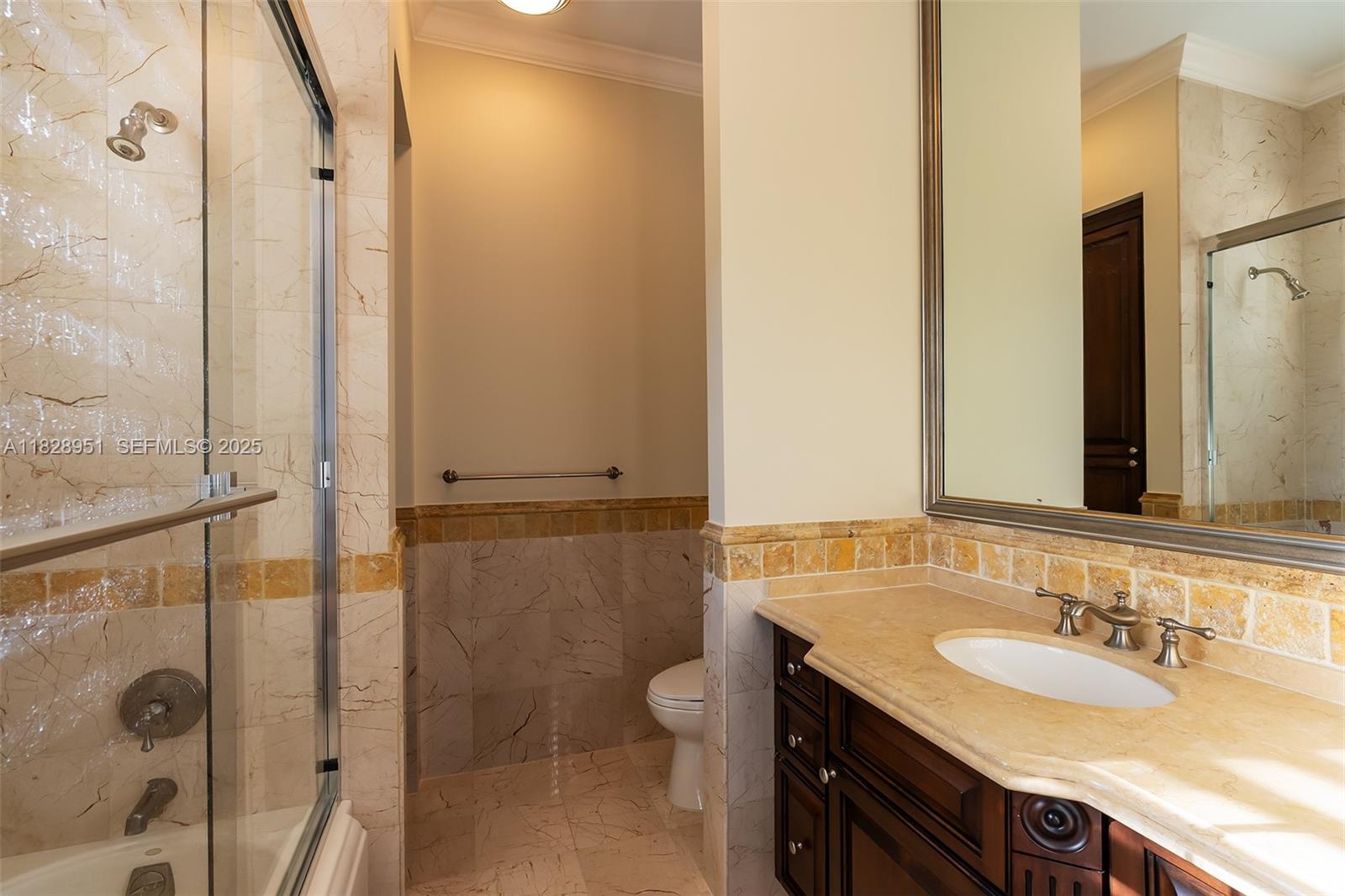 10851 Southwest 63rd Avenue Pinecrest, FL 33156 - Photo 54 of 63 a bathroom with a granite countertop sink toilet and shower
