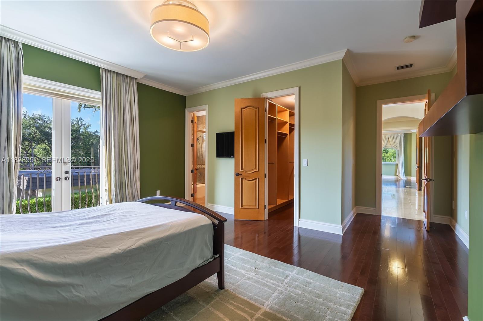 10851 Southwest 63rd Avenue Pinecrest, FL 33156 - Photo 55 of 63 a bedroom with a bed and a large window