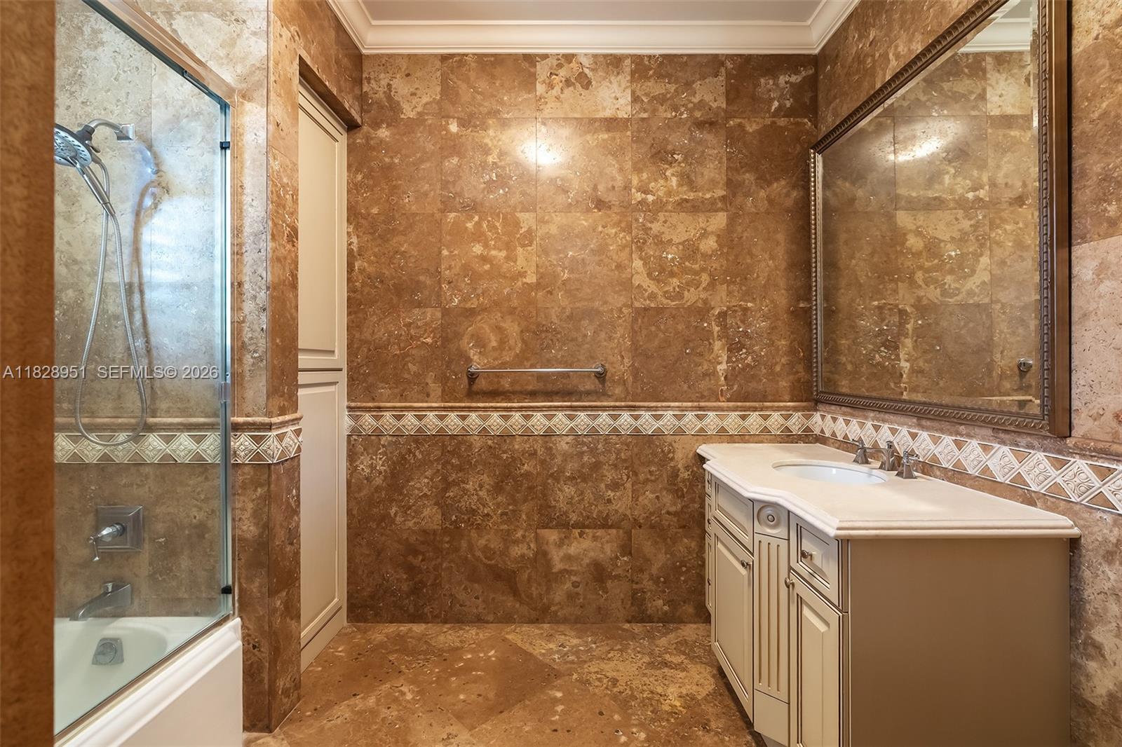 10851 Southwest 63rd Avenue Pinecrest, FL 33156 - Photo 56 of 63 a bathroom with a sink and a mirror
