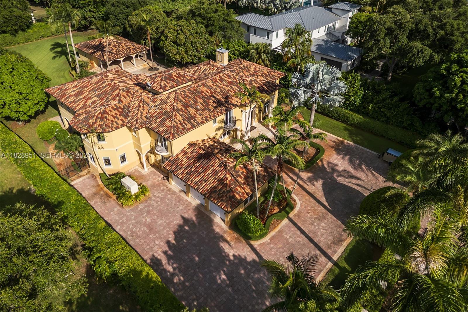 10851 Southwest 63rd Avenue Pinecrest, FL 33156 - Photo 58 of 63 an aerial view of a house with a yard