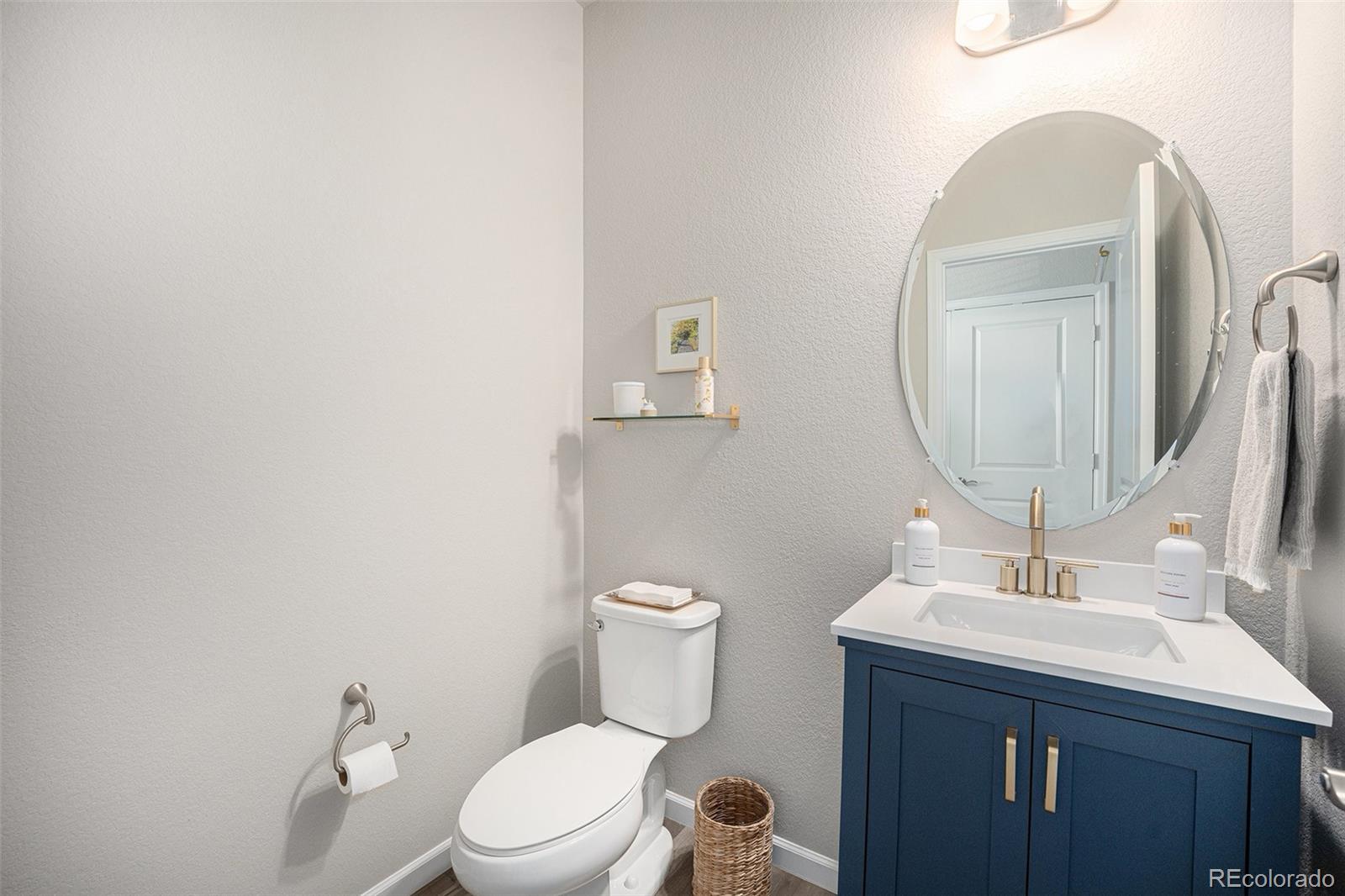 8430 Donati Terrace, Unit A Highlands Ranch, CO 80129 - Photo 11 of 26 a bathroom with a toilet a sink and mirror
