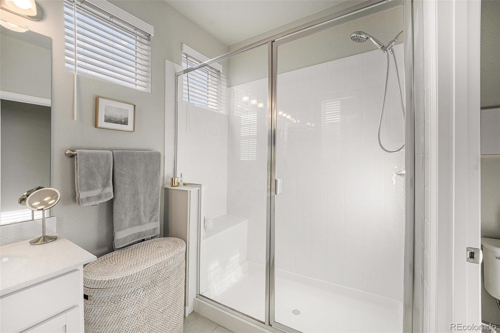 8430 Donati Terrace, Unit A Highlands Ranch, CO 80129 - Photo 14 of 26 a bathroom with a shower and a sink