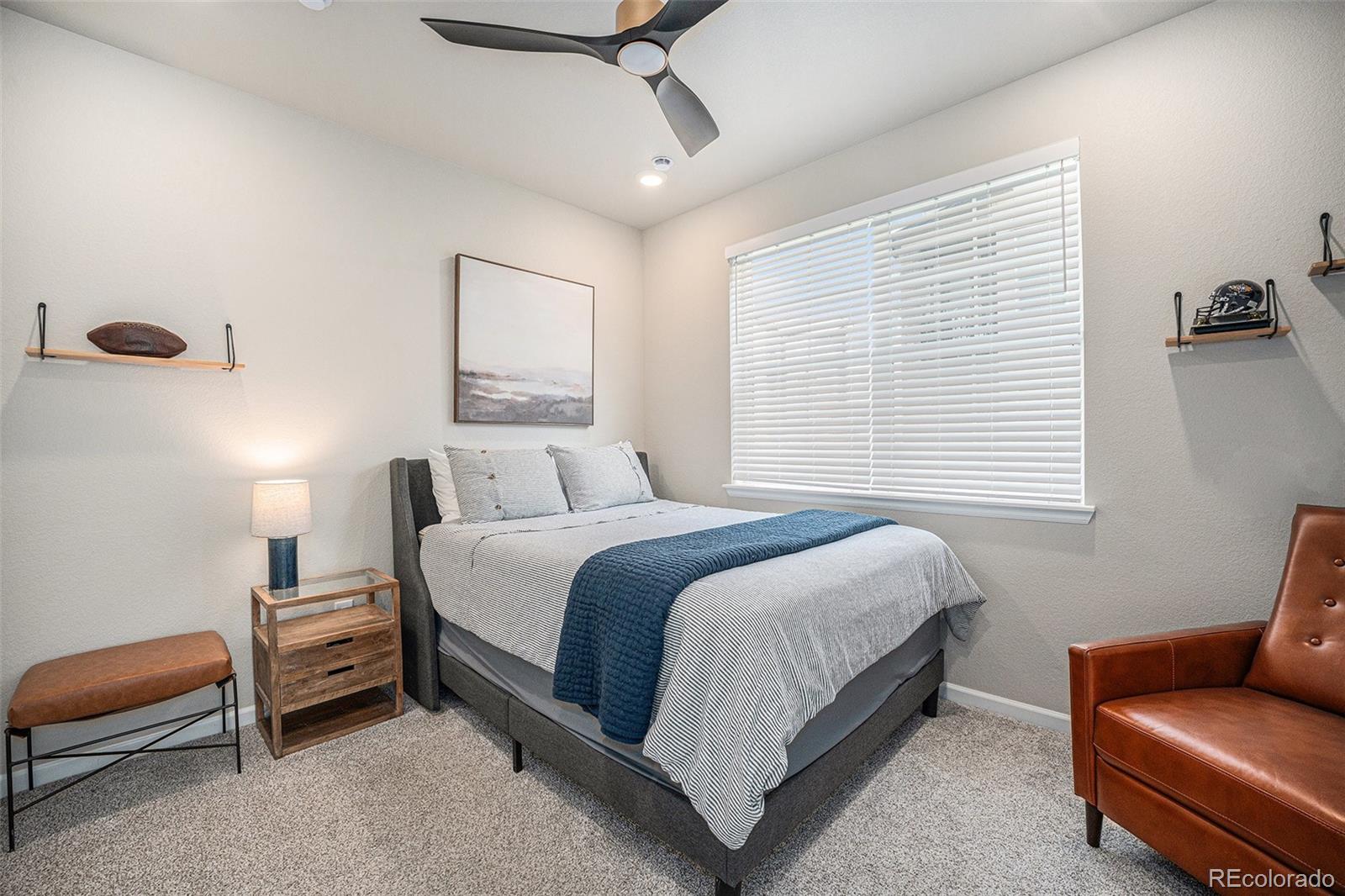 8430 Donati Terrace, Unit A Highlands Ranch, CO 80129 - Photo 20 of 26 a spacious bedroom with a bed a couch and a window