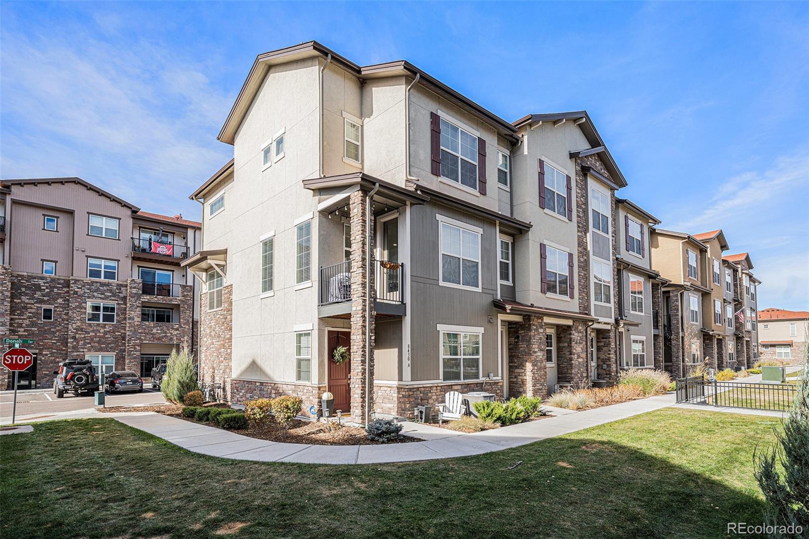 8430 Donati Terrace, Unit A Highlands Ranch, CO 80129 - Photo 22 of 26 a big white building with a yard in front of it