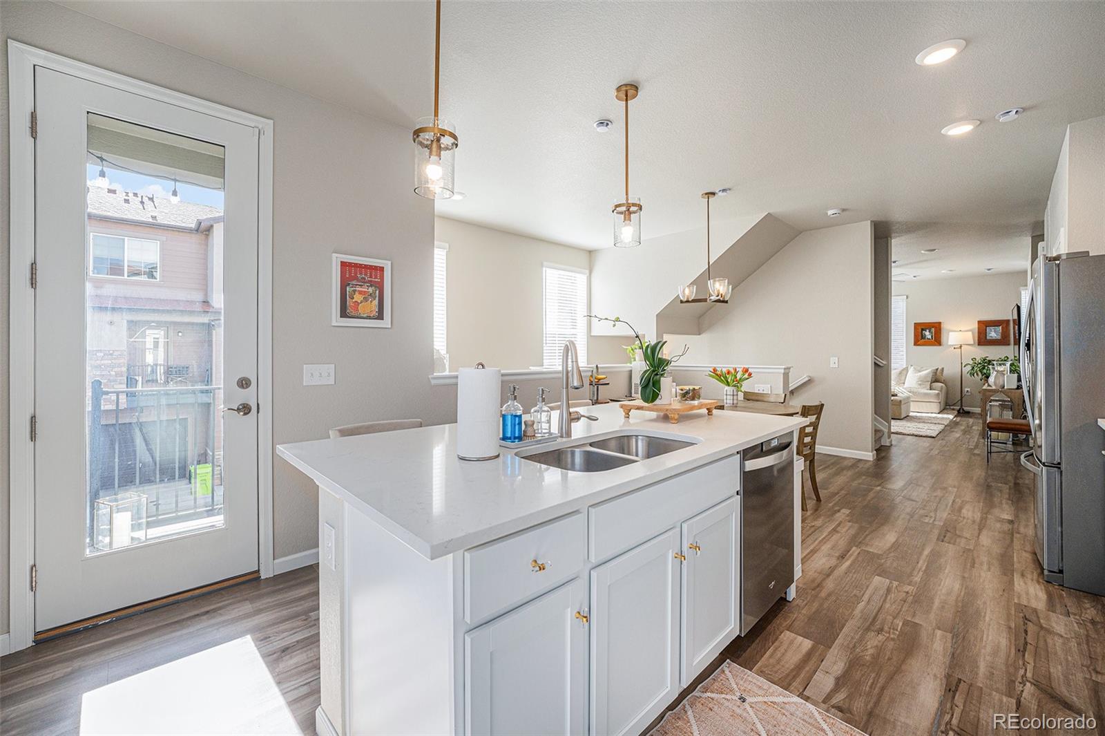 8430 Donati Terrace, Unit A Highlands Ranch, CO 80129 - Photo 6 of 26 a kitchen with a sink a counter space appliances and cabinets