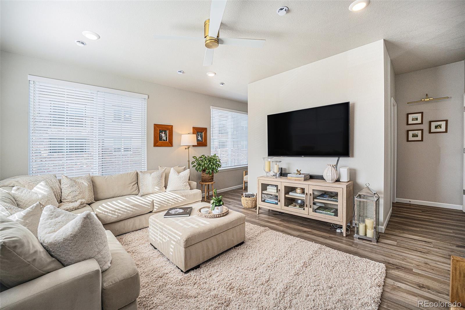 8430 Donati Terrace, Unit A Highlands Ranch, CO 80129 - Photo 8 of 26 a living room with furniture and a flat screen tv