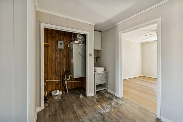a view of a hallway with wooden floor