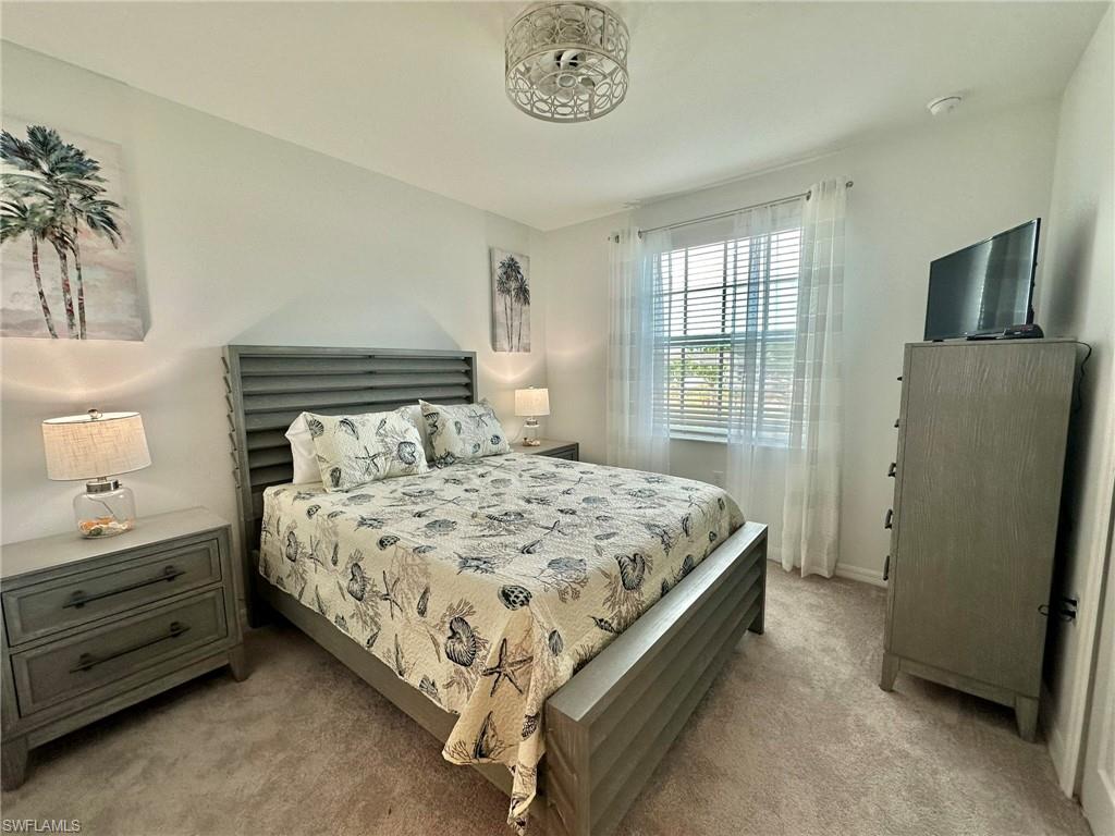 43989 Boardwalk Loop, Unit 2028 Babcock Ranch, FL 33982 - Photo 16 of 47 a bed sitting in a bedroom next to a window
