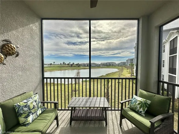 a balcony with furniture and a window