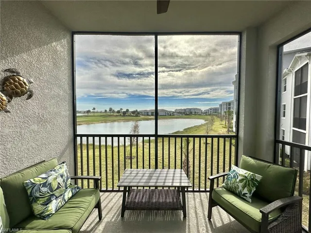 a balcony with furniture and a window