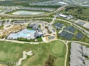 43989 Boardwalk Loop, Unit 2028 Babcock Ranch, FL 33982 - Photo 34 of 47 a swimming pool with trees in the background