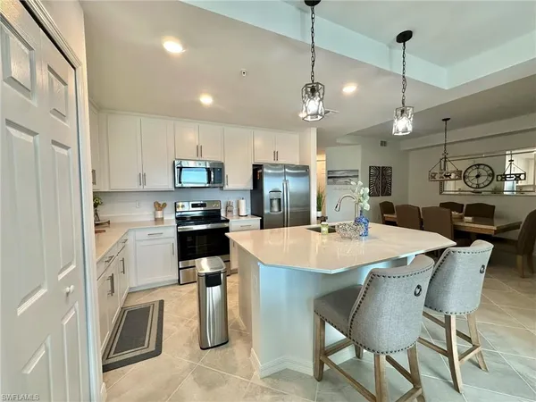 a large kitchen with sink cabinets and stainless steel appliances