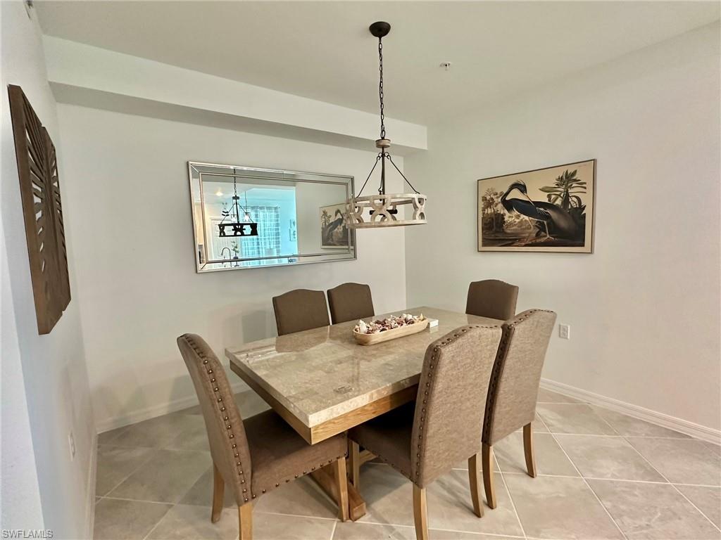 43989 Boardwalk Loop, Unit 2028 Babcock Ranch, FL 33982 - Photo 7 of 47 a view of a dining room with furniture and a chandelier