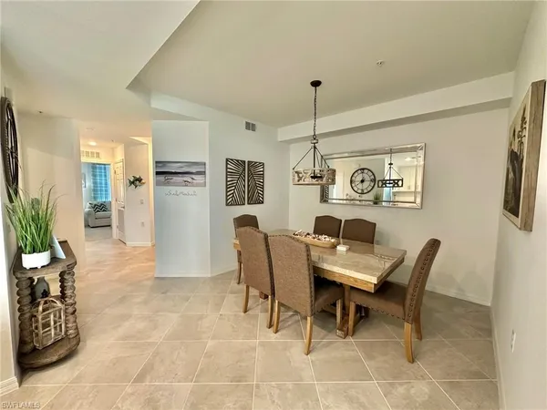 a dining room with furniture and window