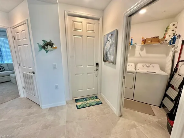 a view of a hallway with wooden floor and entryway