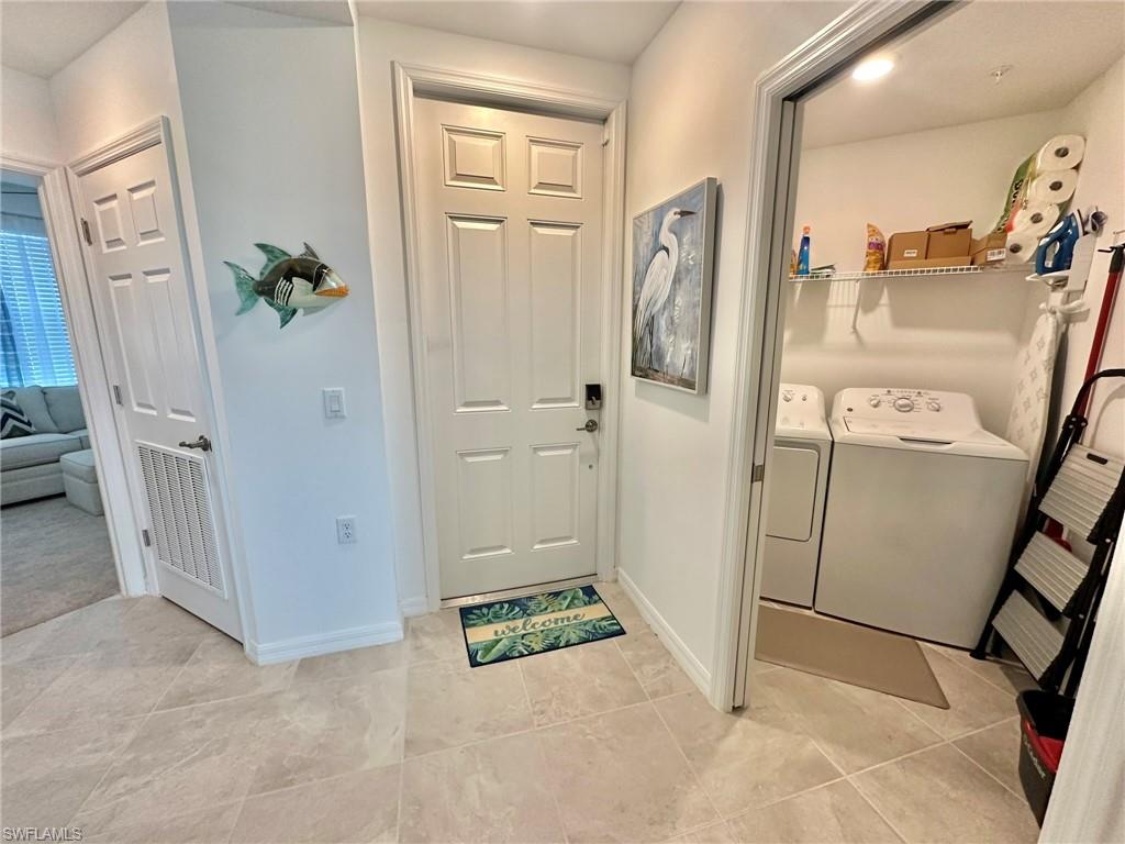 43989 Boardwalk Loop, Unit 2028 Babcock Ranch, FL 33982 - Photo 9 of 47 a view of a hallway with wooden floor and entryway