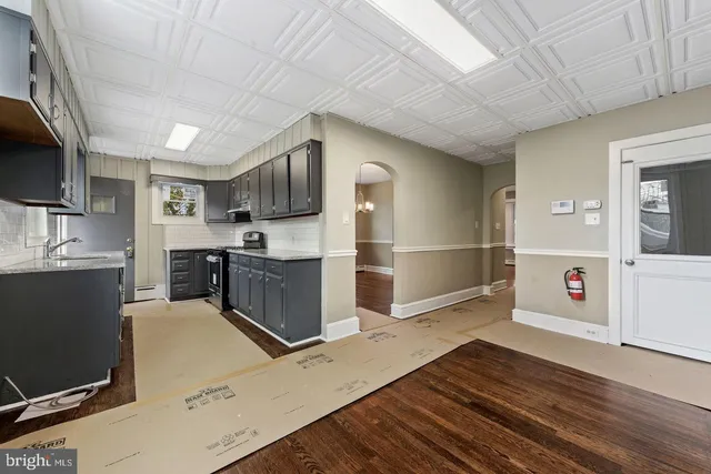 a kitchen with stainless steel appliances granite countertop a refrigerator and a stove top oven