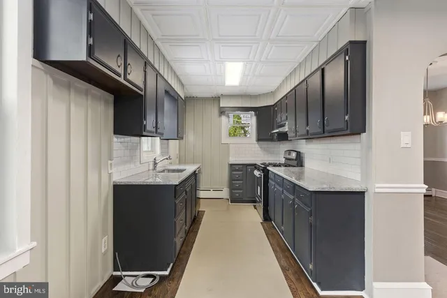 a kitchen with stainless steel appliances granite countertop a refrigerator a sink dishwasher a stove and a microwave oven