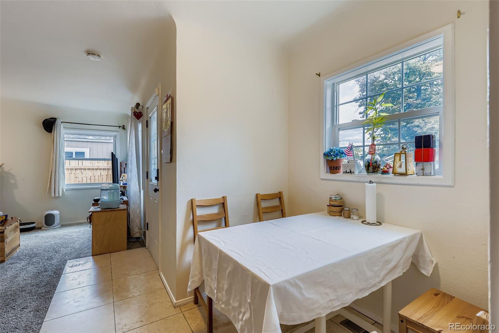 452 Perry Street Denver, CO 80204 - Photo 11 of 29 a view of a dining room with furniture window and outside view