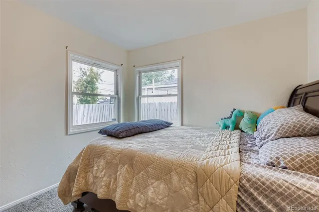 a bedroom with a bed and window