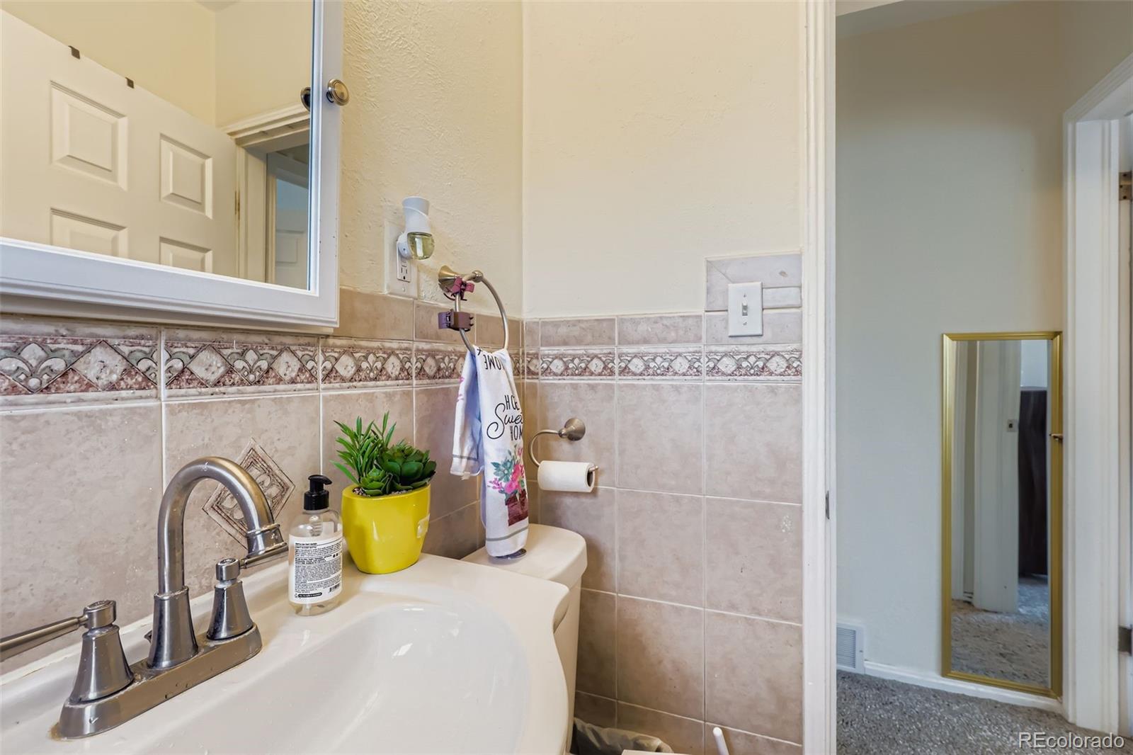 452 Perry Street Denver, CO 80204 - Photo 20 of 29 a bathroom with a sink a toilet and shower