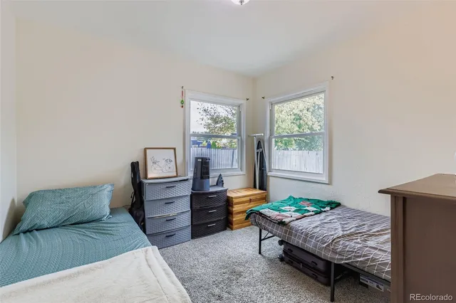 a living room with a bed and furniture