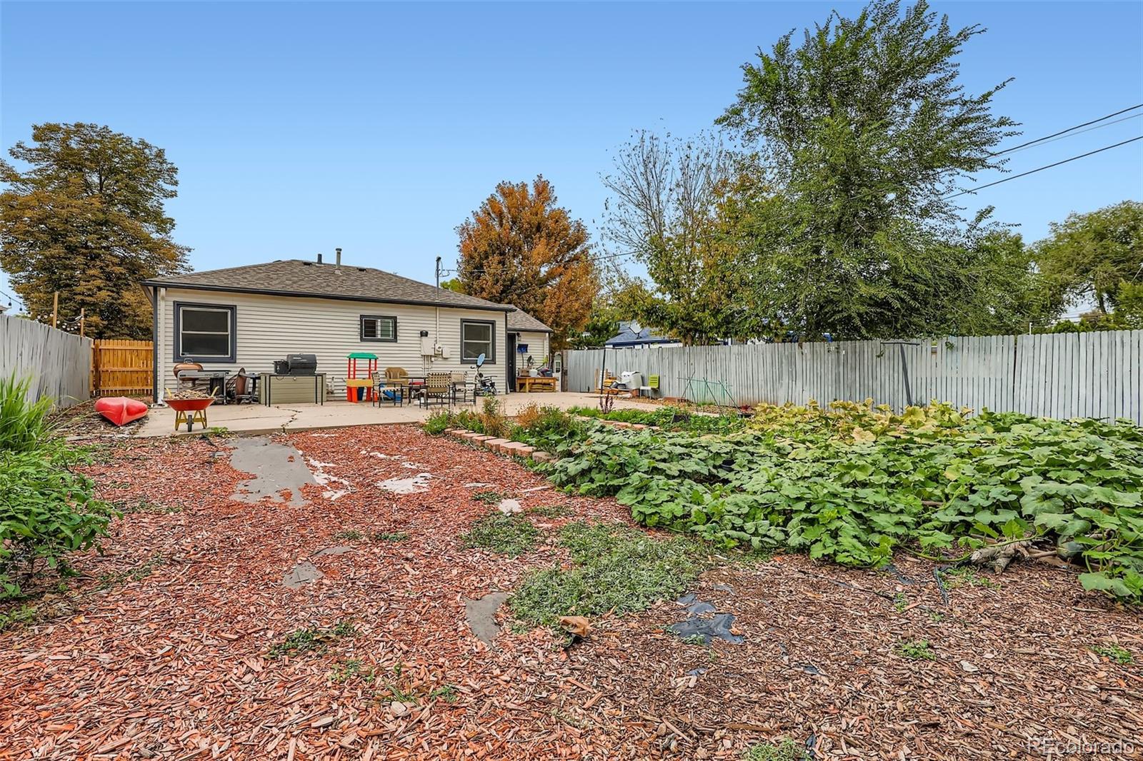 452 Perry Street Denver, CO 80204 - Photo 26 of 29 a front view of a house with a yard table and chairs