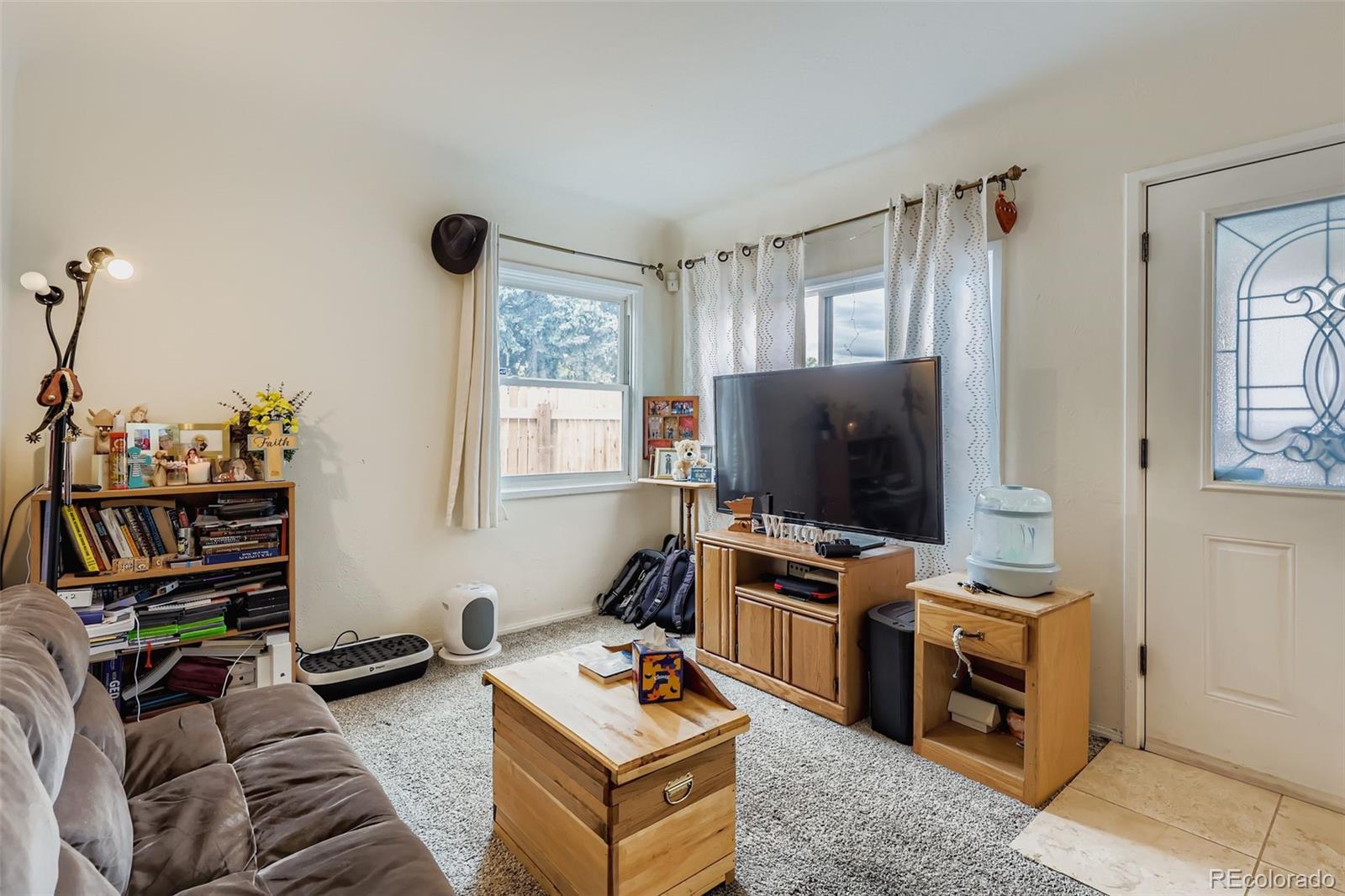 452 Perry Street Denver, CO 80204 - Photo 6 of 29 a living room with furniture and a flat screen tv