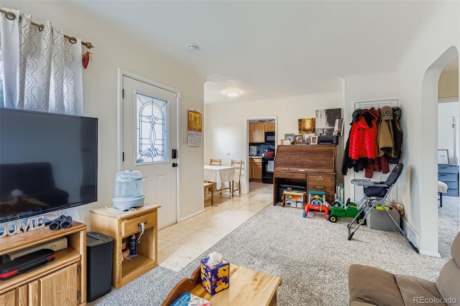 452 Perry Street Denver, CO 80204 - Photo 9 of 29 a bed room with a bed and a television