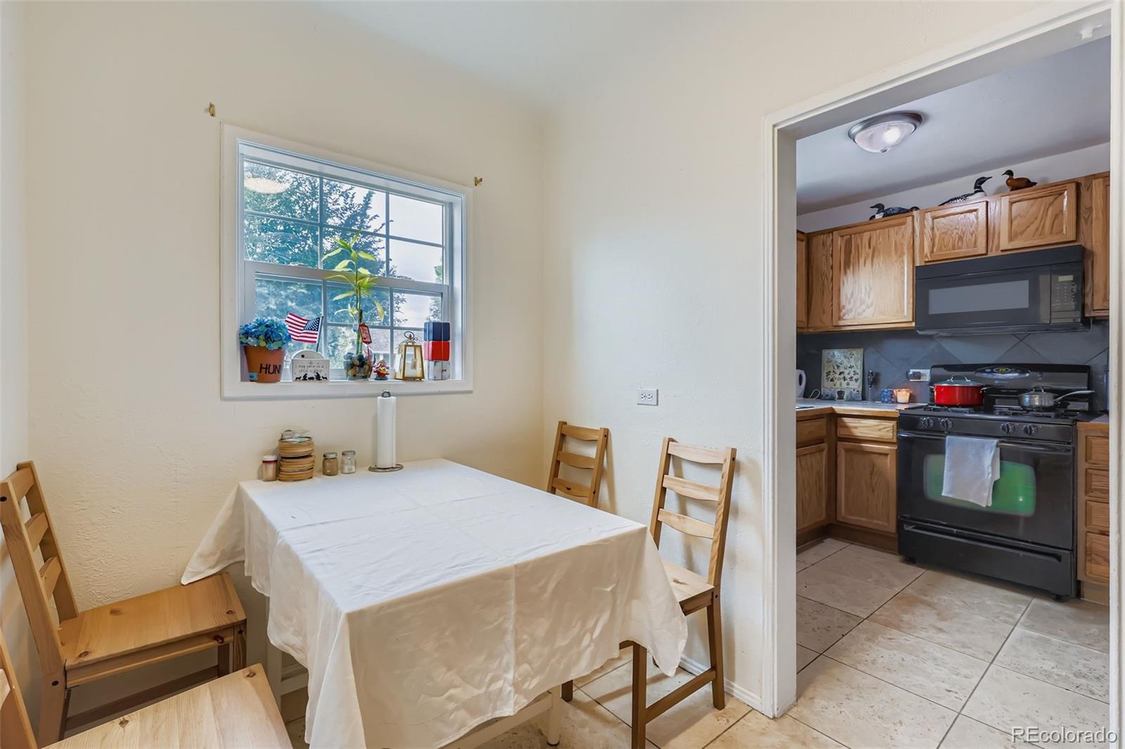 452 Perry Street Denver, CO 80204 - Photo 10 of 29 a kitchen that has a table and chair in it