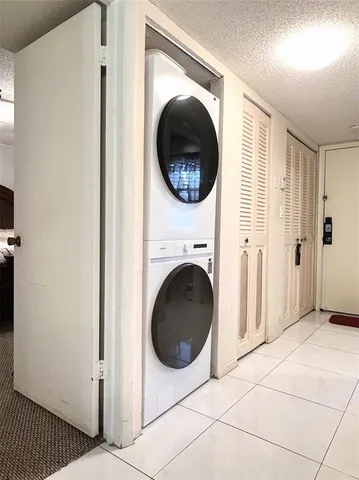 a view of a hallway with washer and dryer