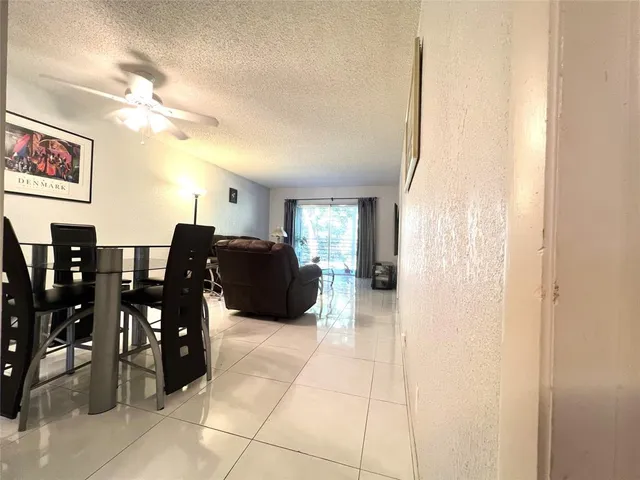 a living room with furniture a dining table and chairs