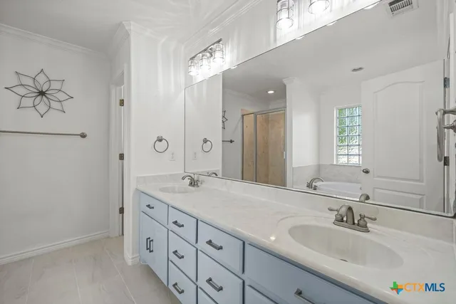 a bathroom with a double vanity sink and a mirror