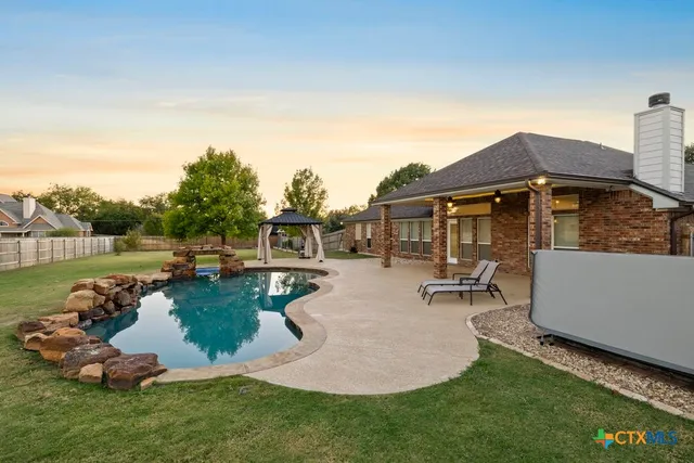 a view of a terrace with a table and chairs