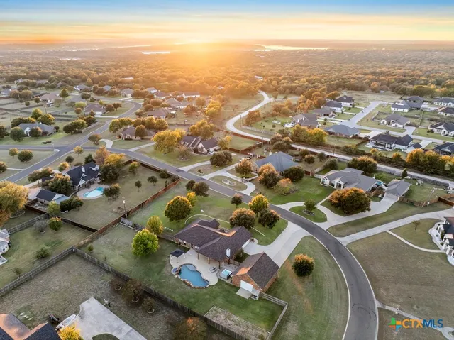 an aerial view of a house with a swimming pool