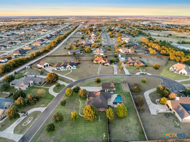 an aerial view of a house with a swimming pool
