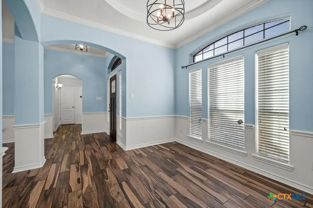a view of a room with wooden floor and a window