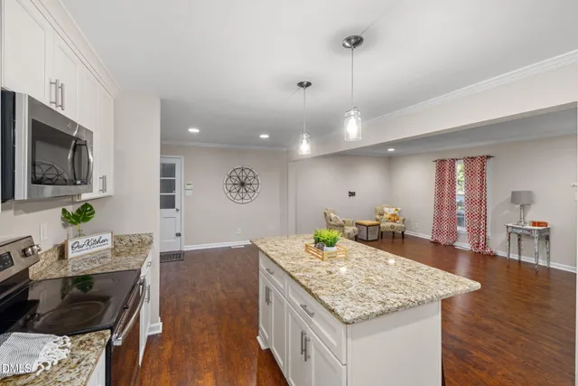 a living room with granite countertop furniture and wooden floor