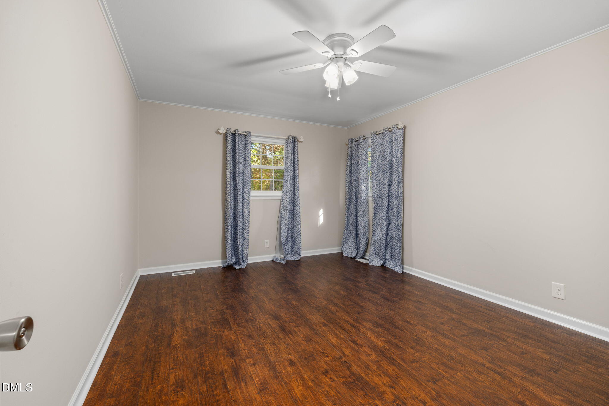 415 Bashford Road Raleigh, NC 27606 - Photo 18 of 33 an empty room with wooden floor chandelier fan and windows