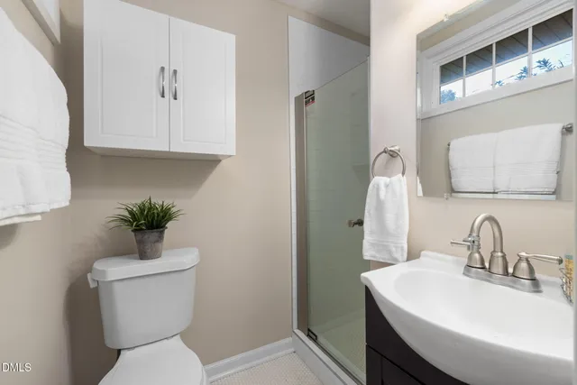 a bathroom with a sink toilet and a mirror